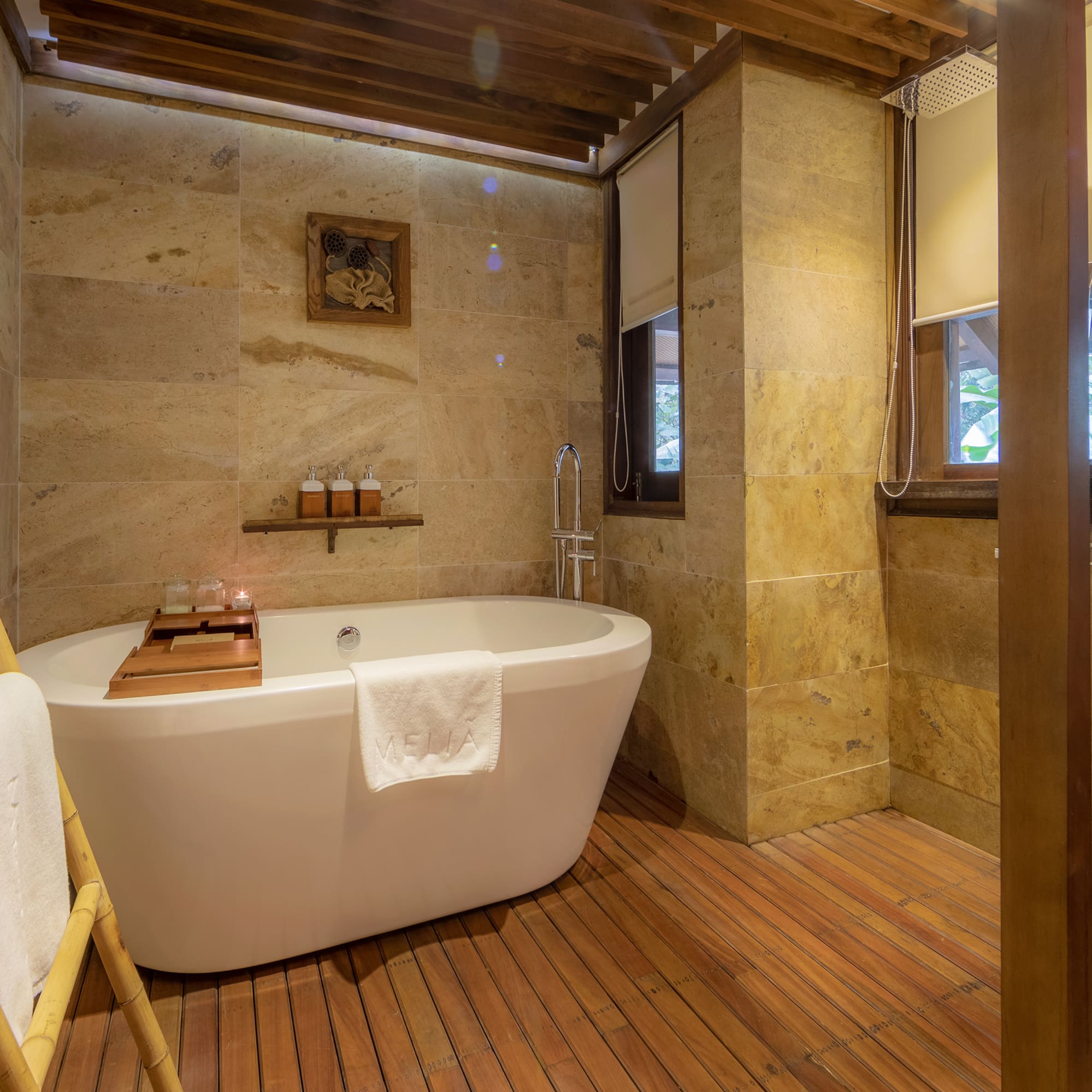 a bathroom with a tub and a wood floor