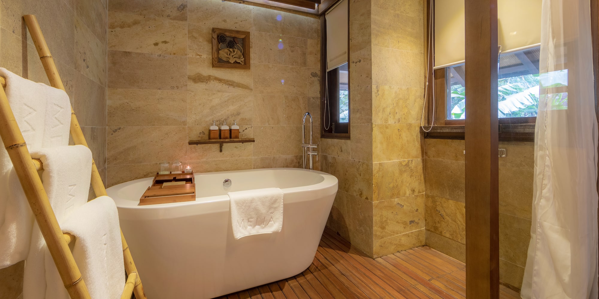 a bathroom with a tub and a wood floor