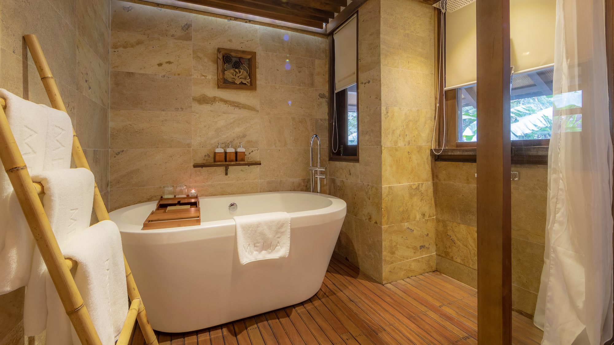 a bathroom with a tub and a wood floor