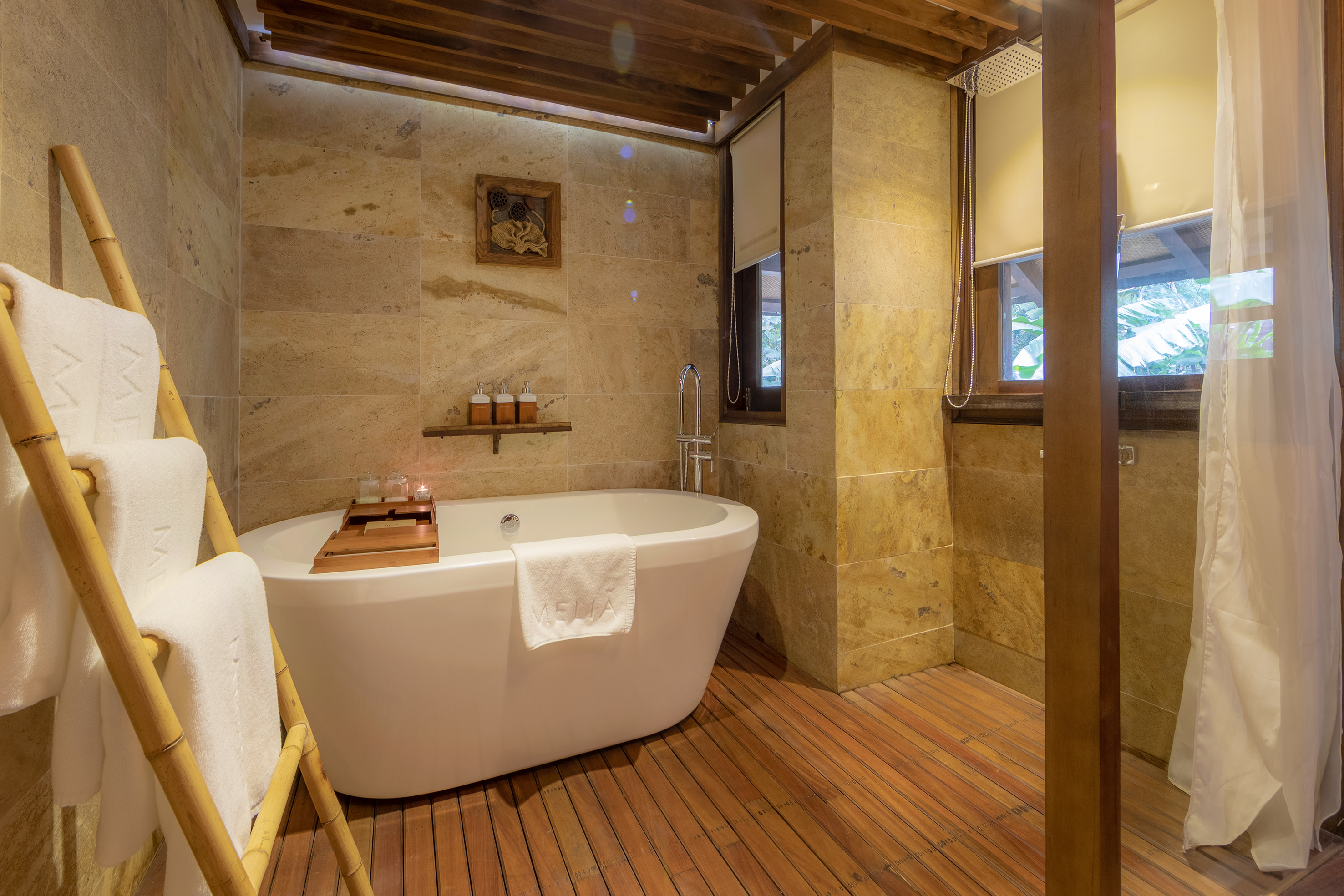 a bathroom with a tub and a wood floor