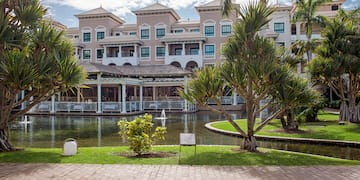 a building with a pond and trees
