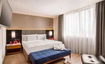 a bedroom with a bed and a stool