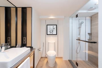 a bathroom with a toilet and a shower