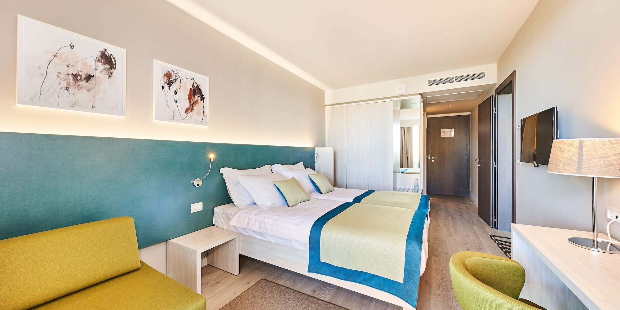 a room with a bed and chairs