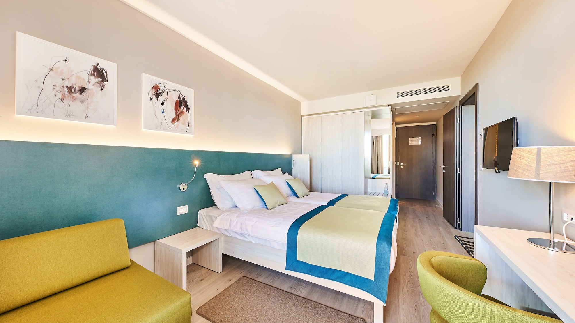 a room with a bed and chairs