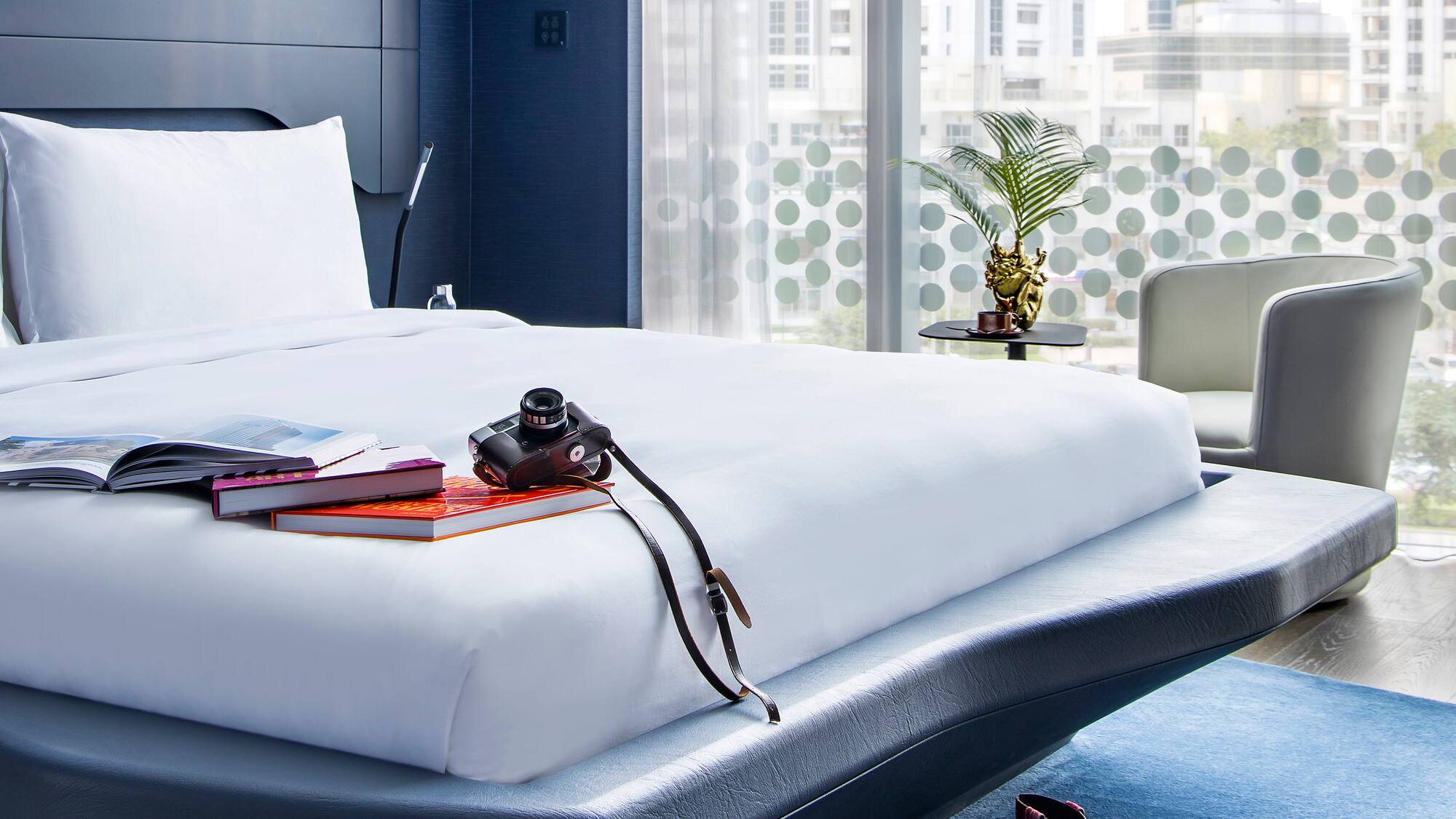 a bed with a camera and books on it