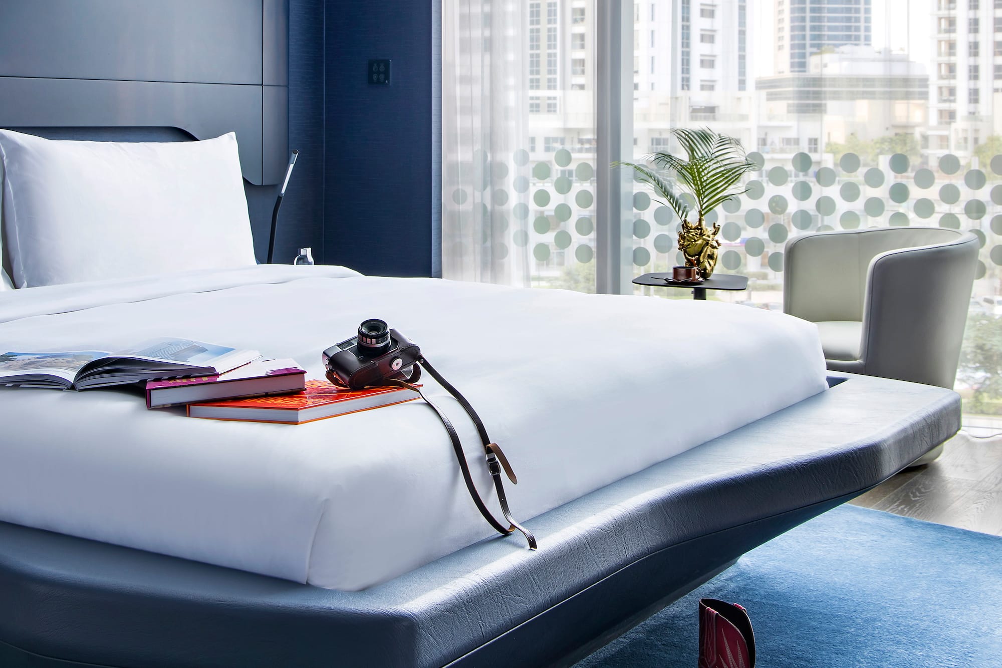 a bed with a camera and books on it