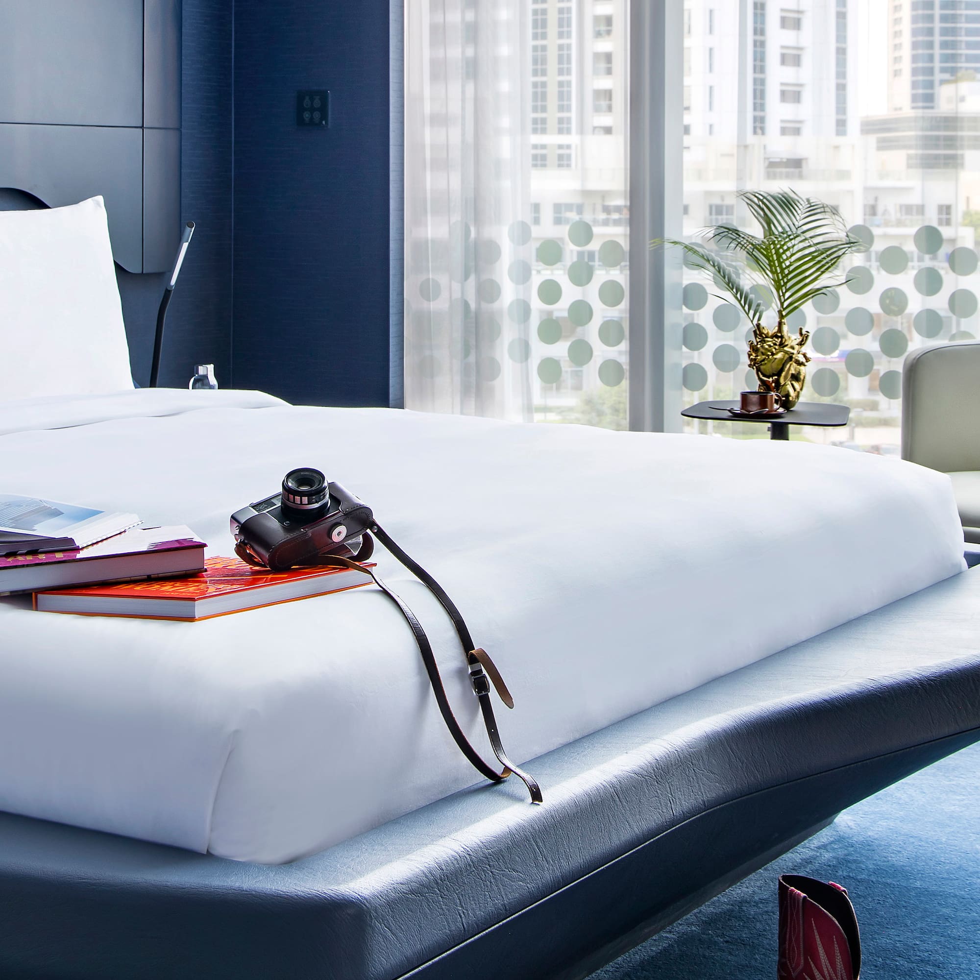 a bed with a camera and books on it