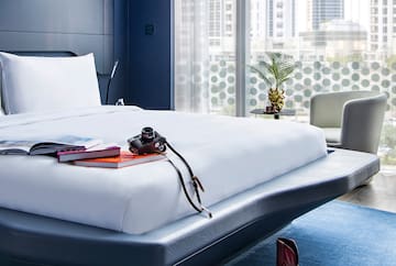 a bed with a camera and books on it