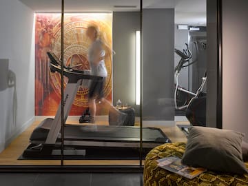 a woman running on a treadmill in a room