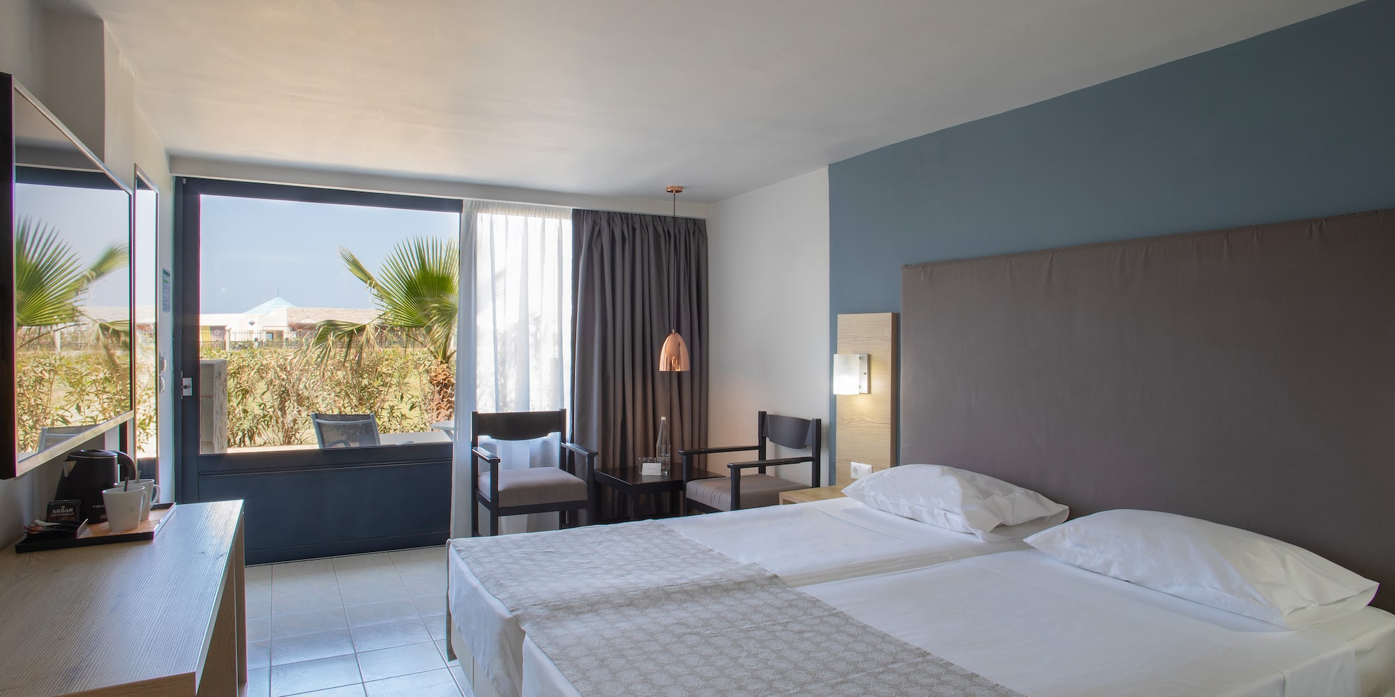 a room with two beds and a window