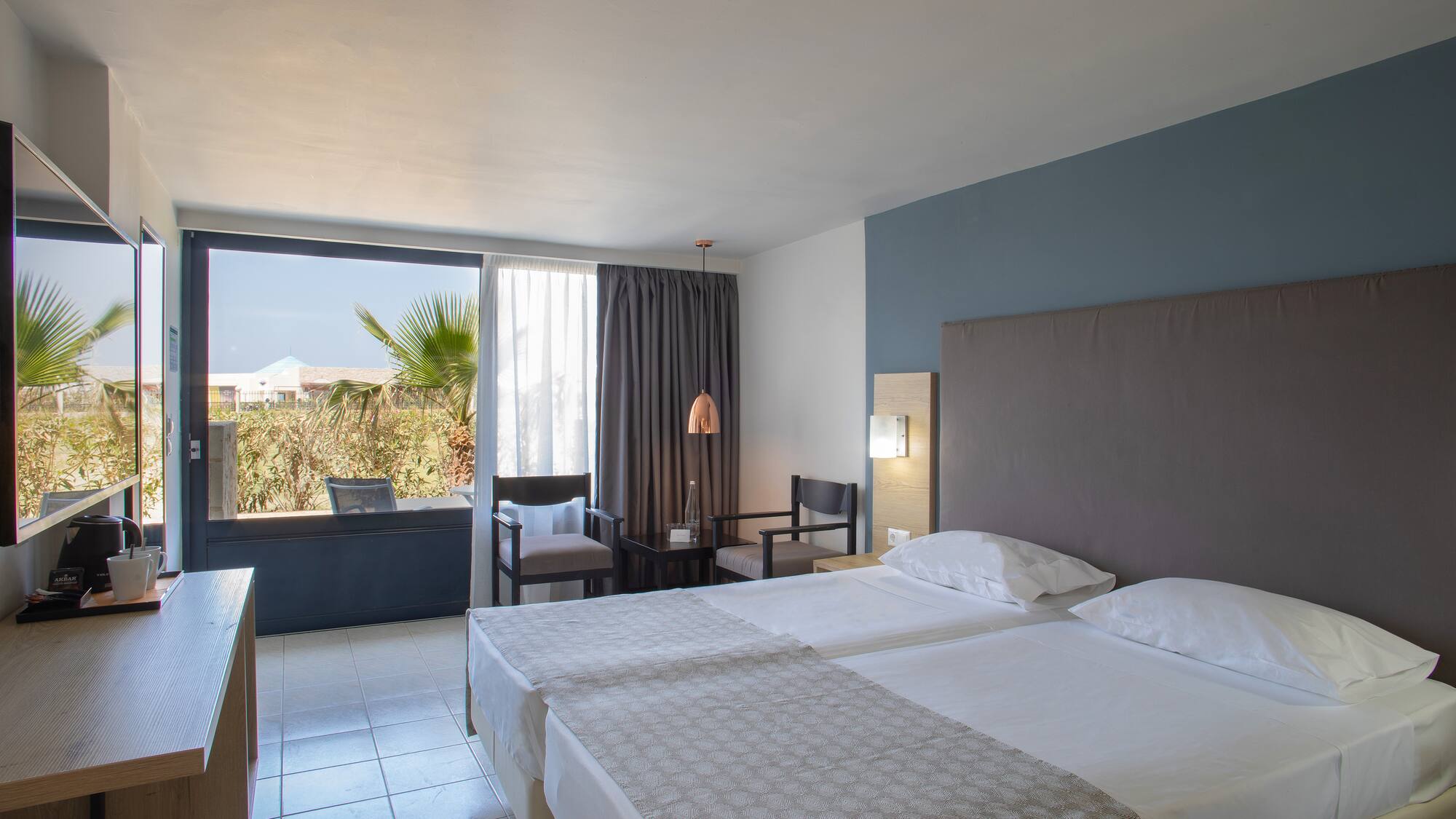 a room with two beds and a window