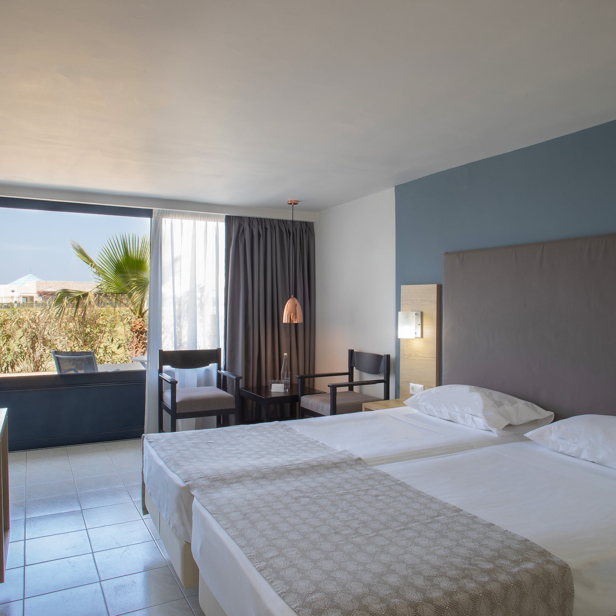 a room with two beds and a window