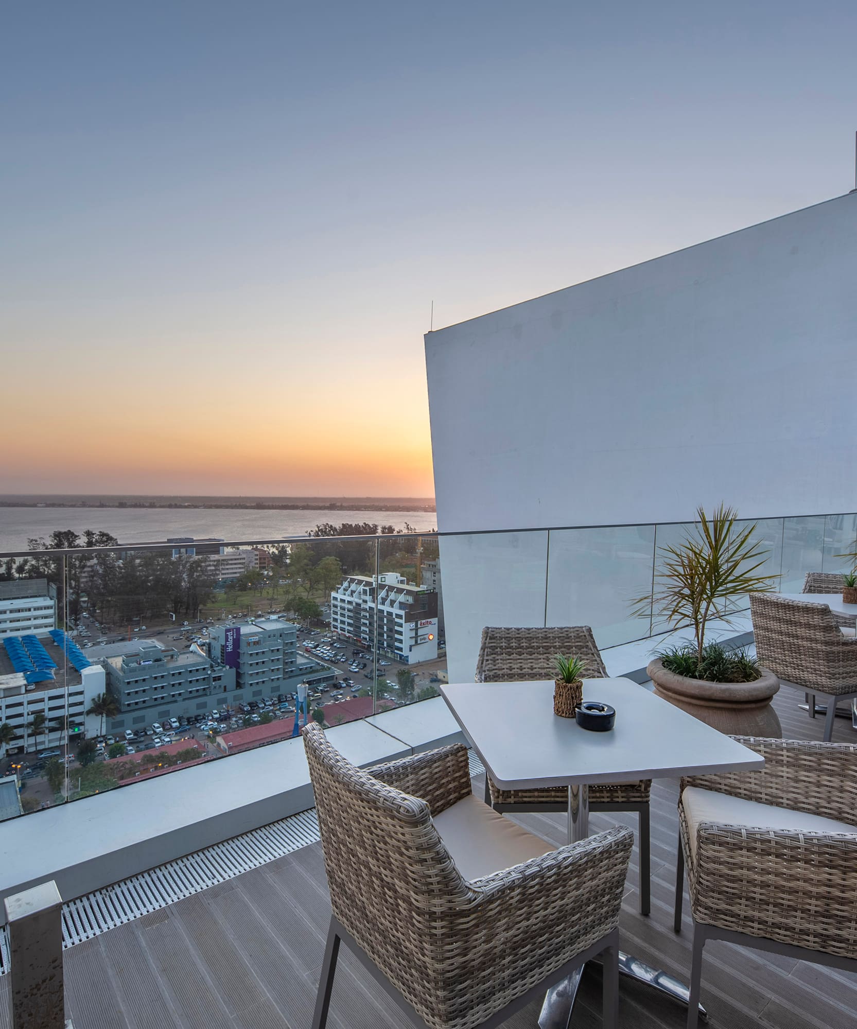 a table and chairs on a balcony overlooking a city
