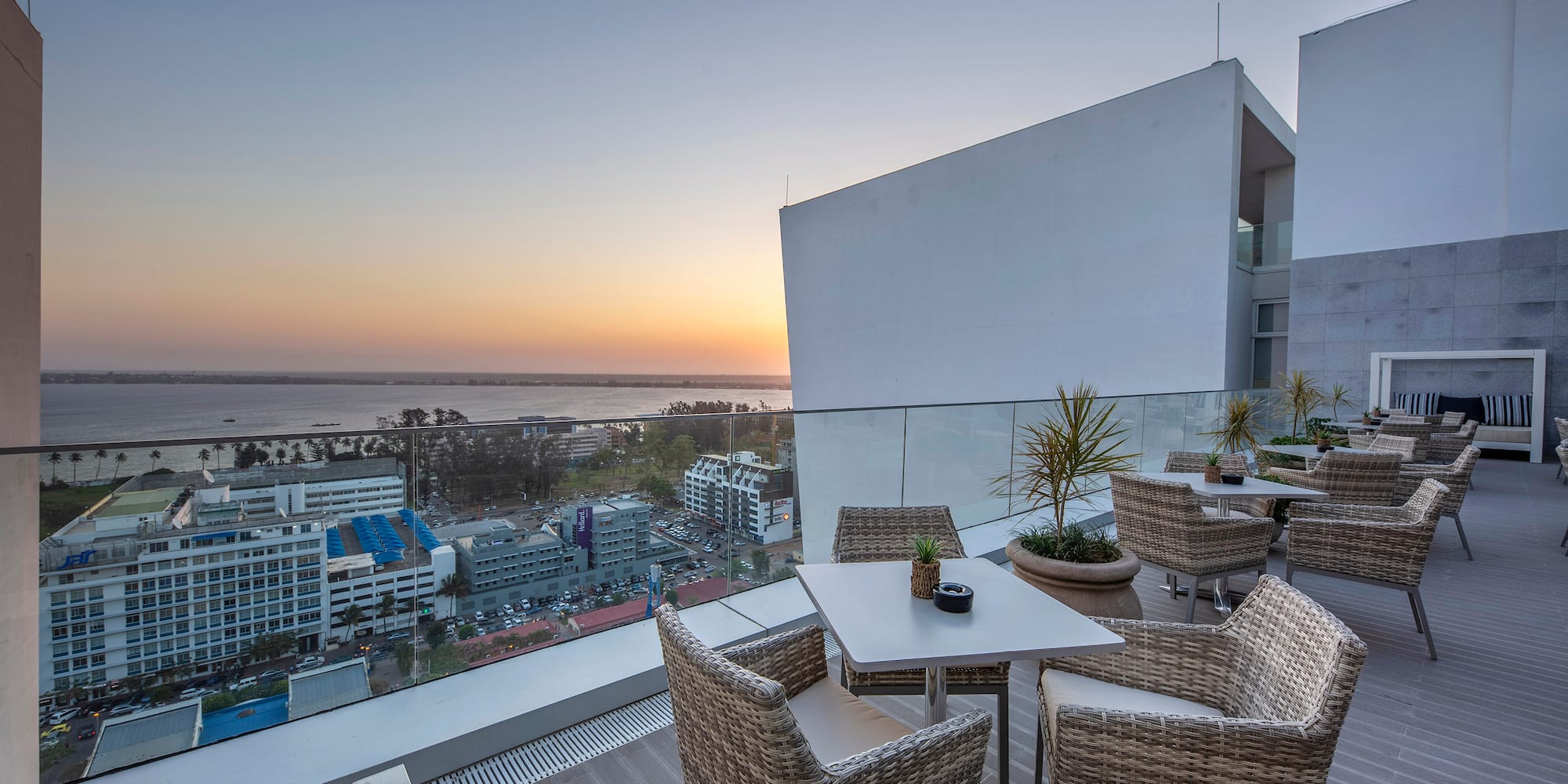 a table and chairs on a balcony overlooking a city