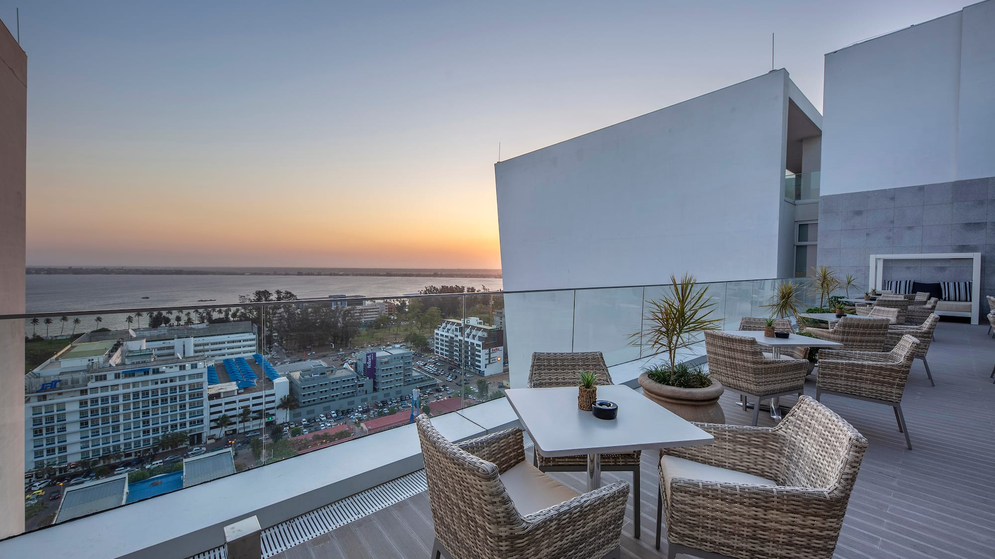 a table and chairs on a balcony overlooking a city