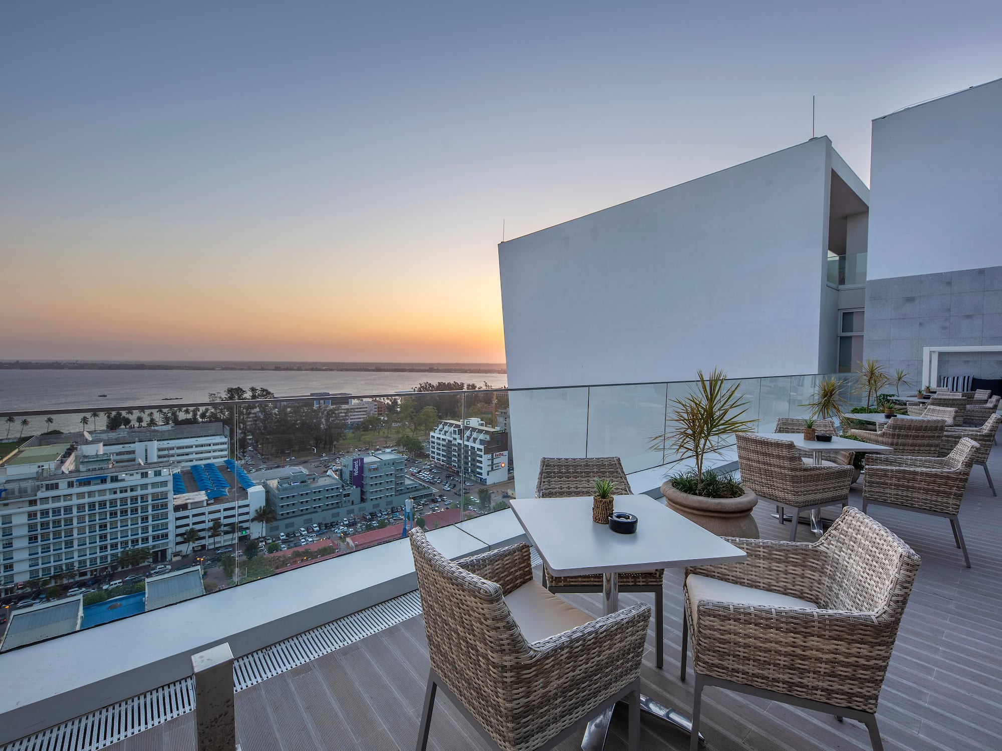 a table and chairs on a balcony overlooking a city