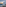 Outdoor rooftop dining terrace overlooking city skyline and ocean at sunset.