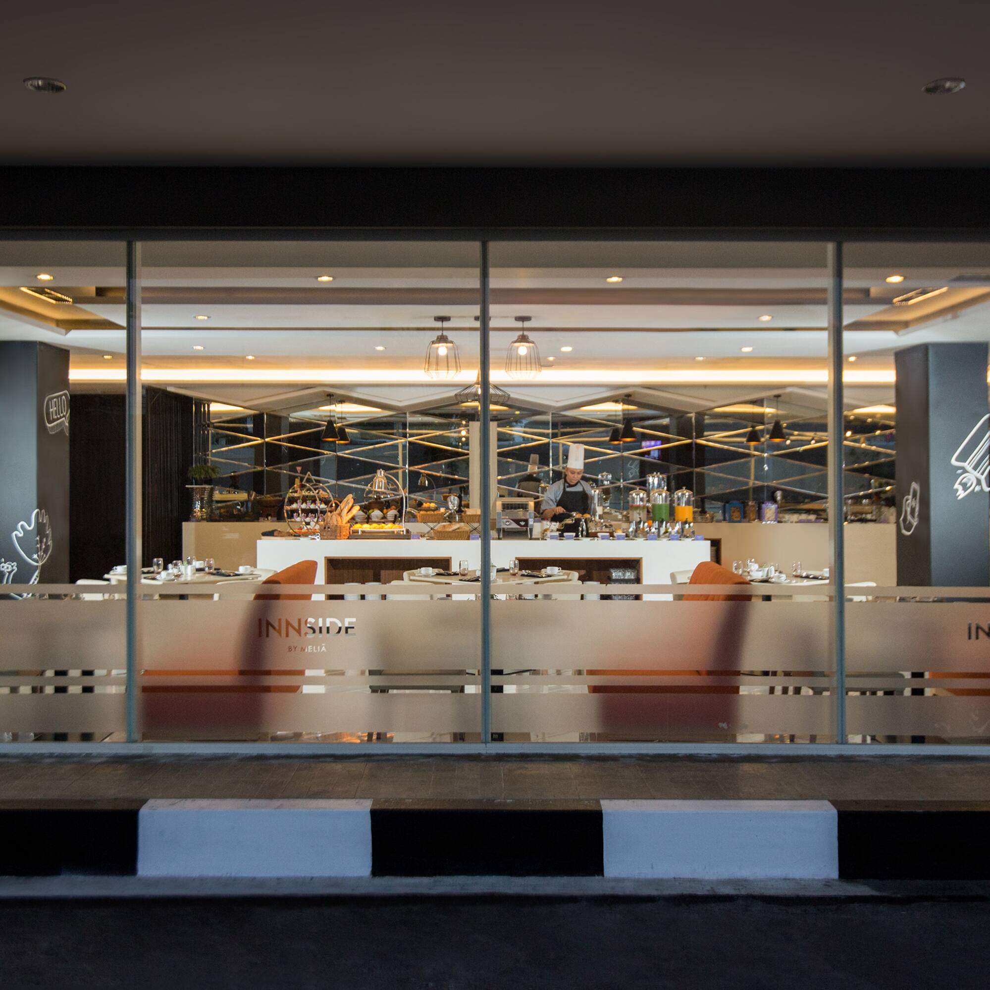 INNSIDE by MELIA hotel buffet restaurant interior with chef.