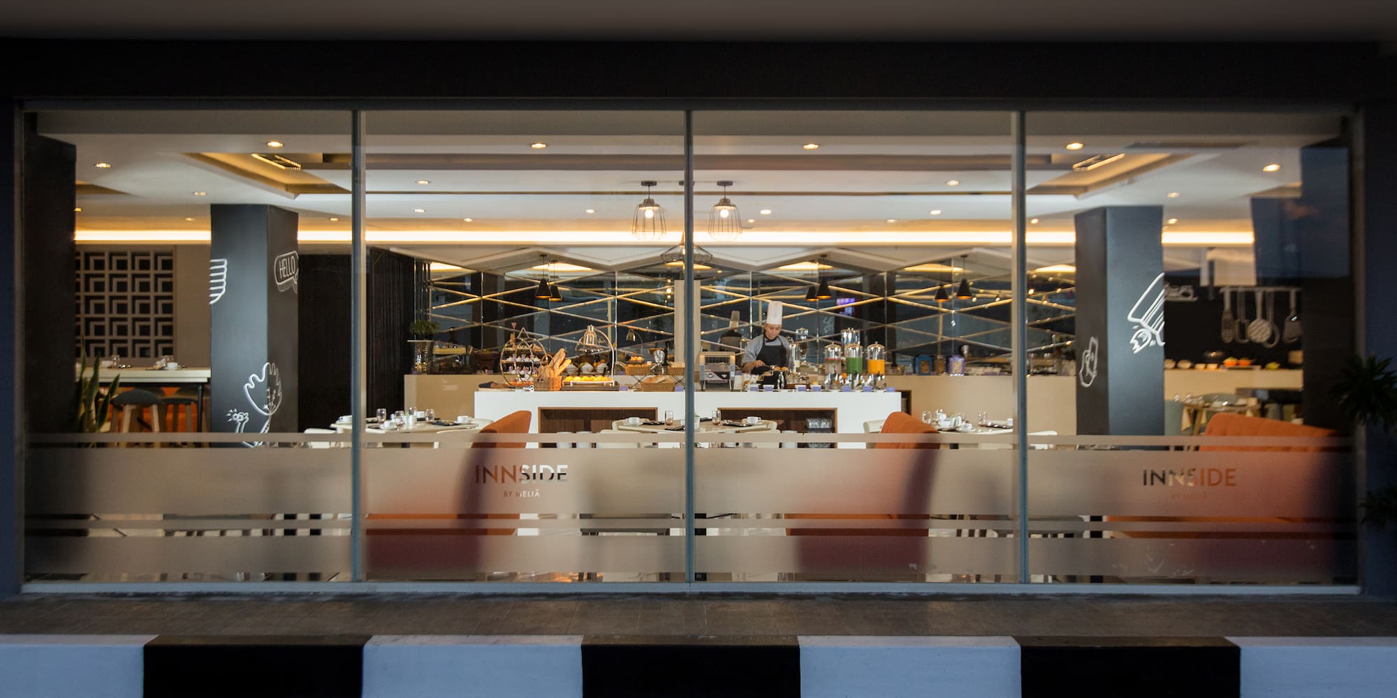 a glass wall with a bar and a person behind it