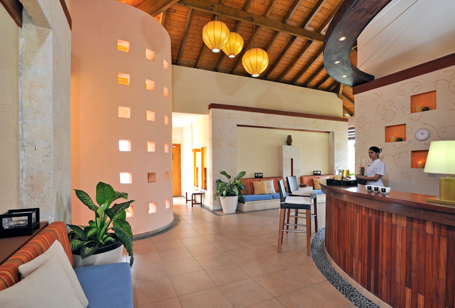 a room with a bar and a woman standing behind it