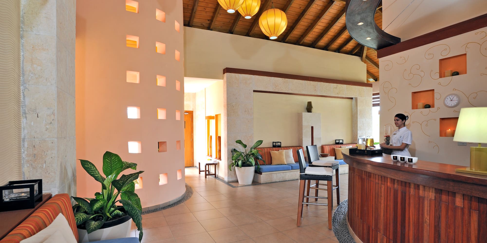 a room with a bar and a woman standing behind it