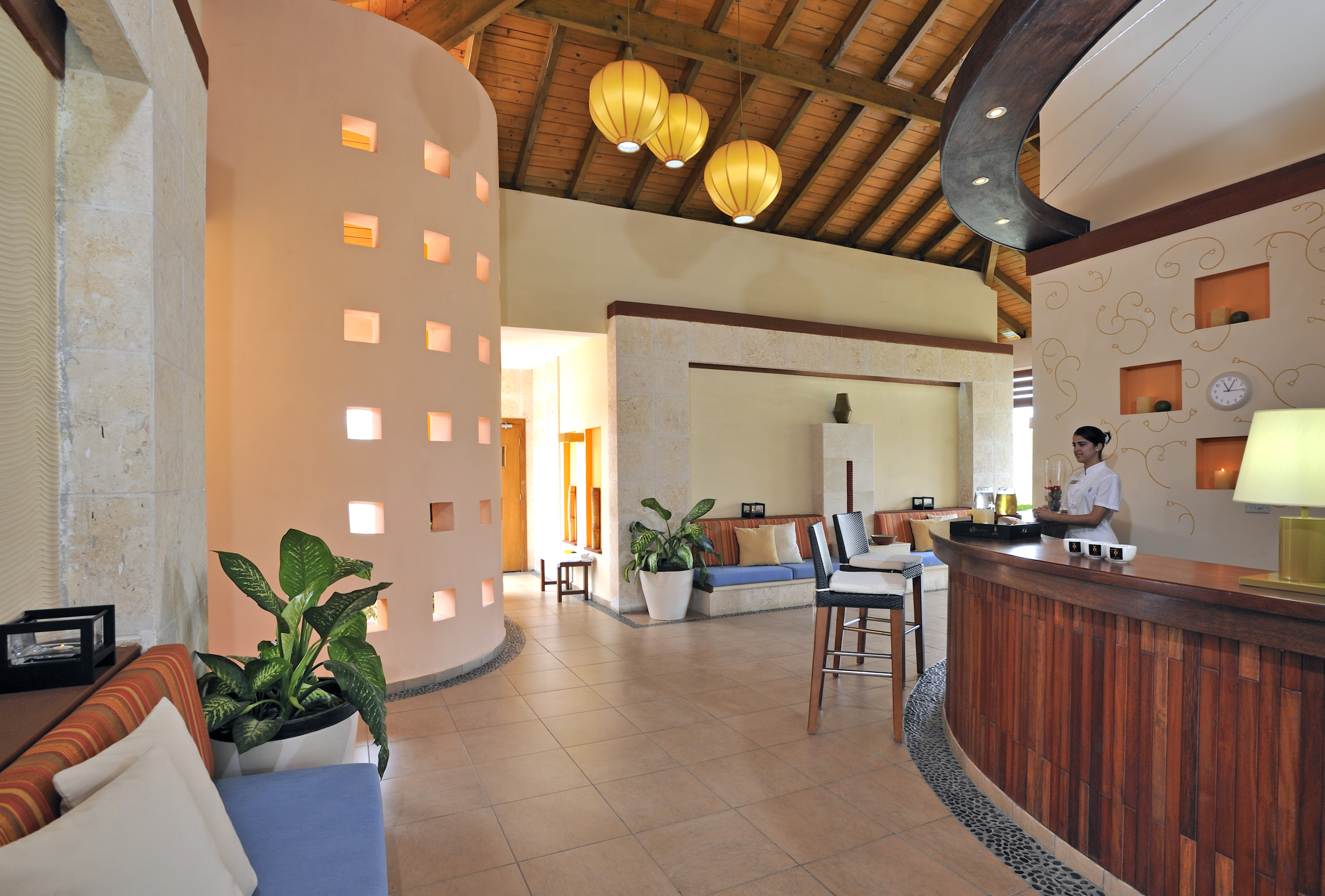 a room with a bar and a woman standing behind it