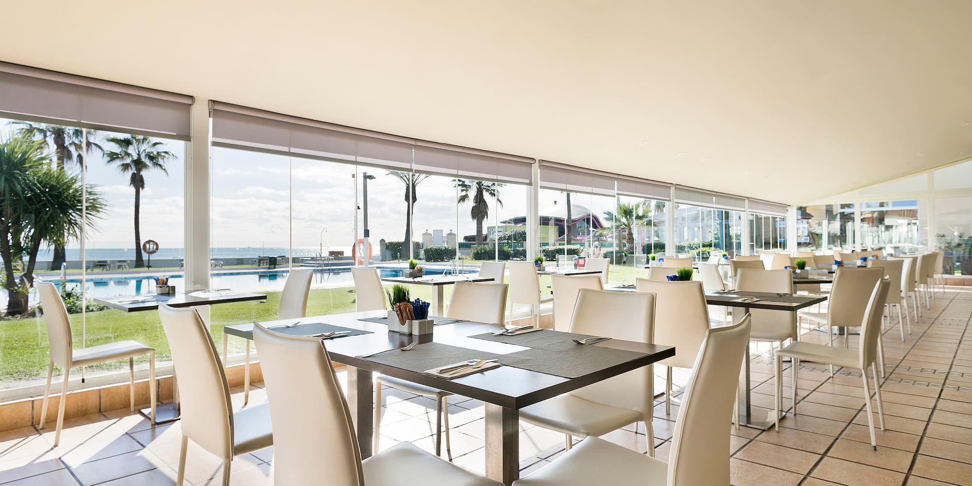 a room with white chairs and tables