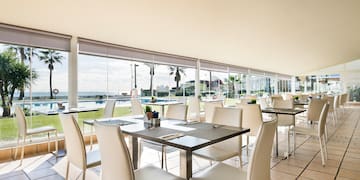 a room with white chairs and tables