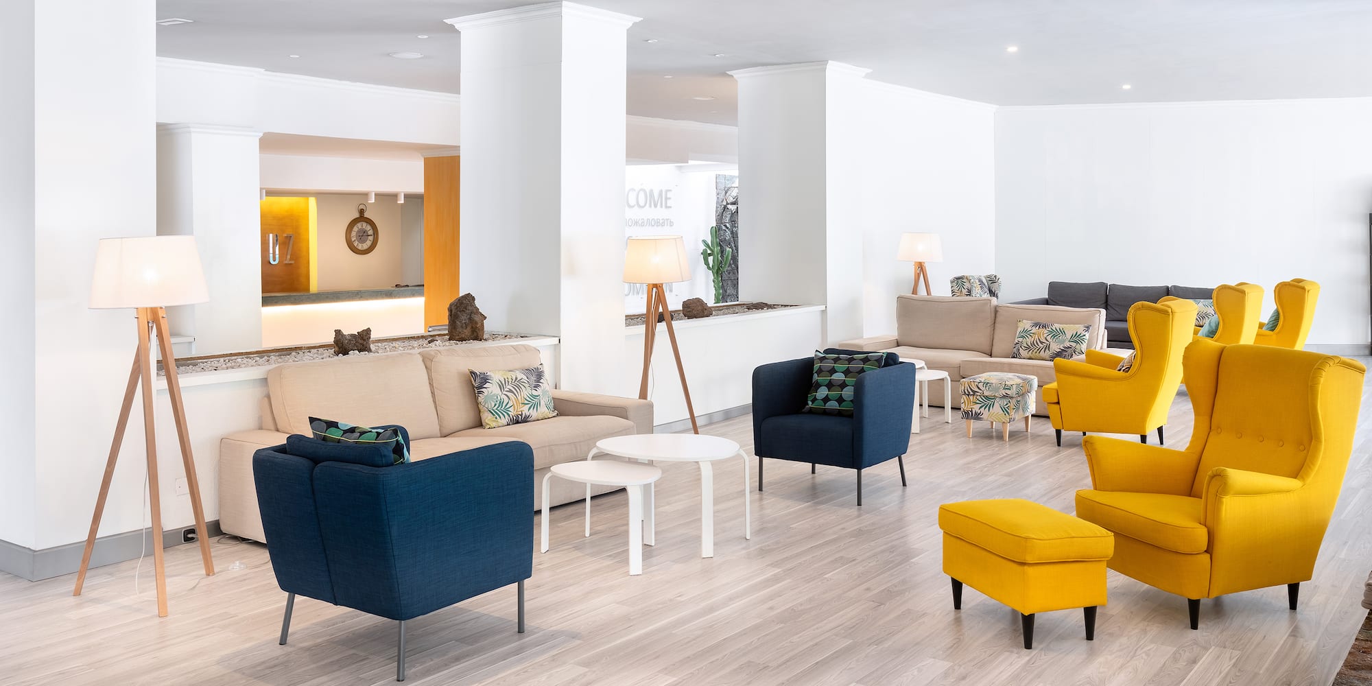 a room with a large white wall and a white column