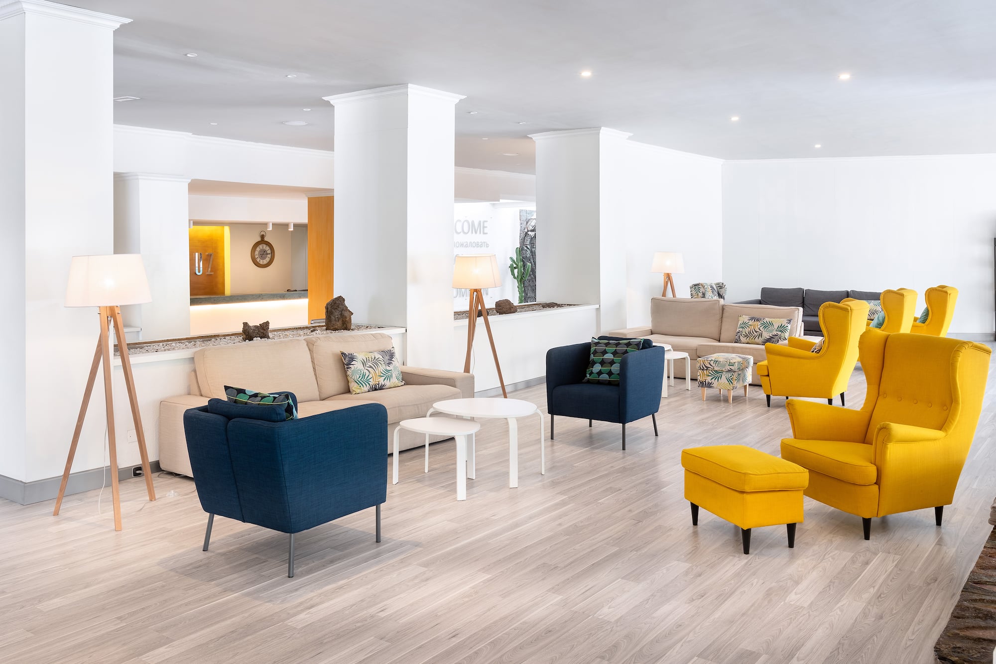 a room with a large white wall and a white column