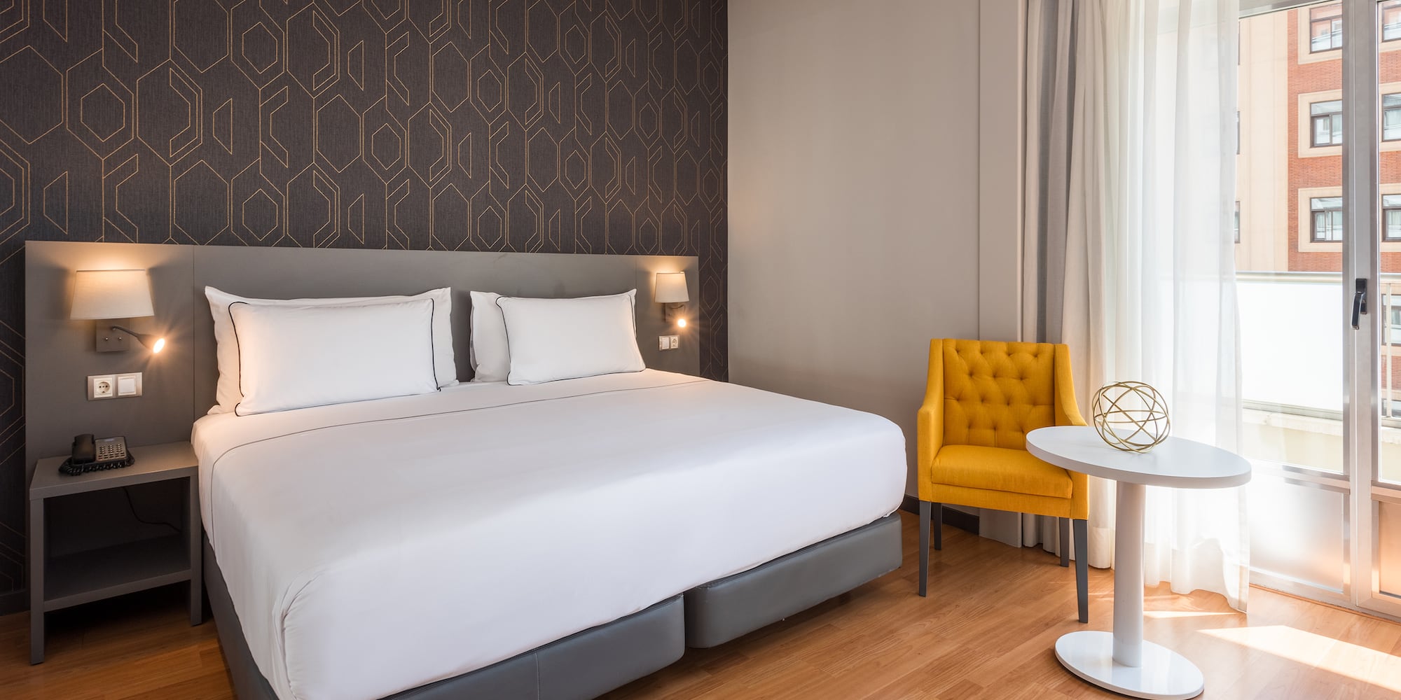 a bed with a table and chair in a room