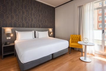 a bed with a table and chair in a room