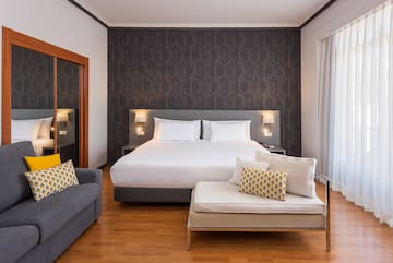 a bedroom with a bed and a couch