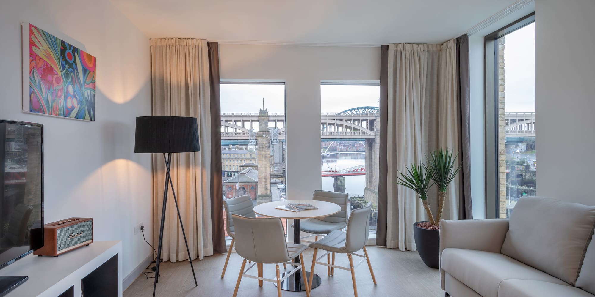 a room with a table and chairs and a tv