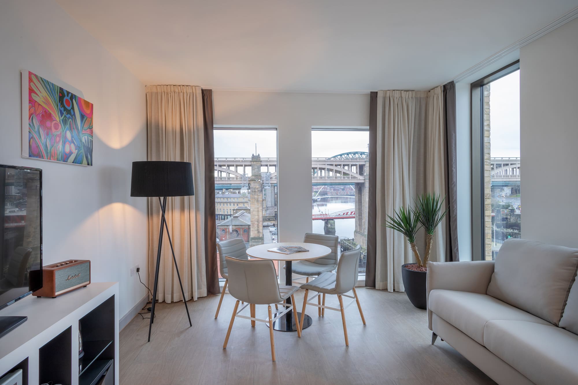 a room with a table and chairs and a tv