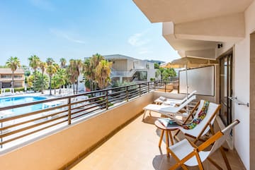 a deck with chairs and umbrellas on a balcony