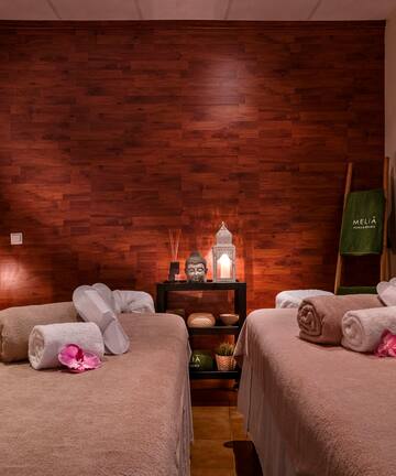 a room with two beds and candles