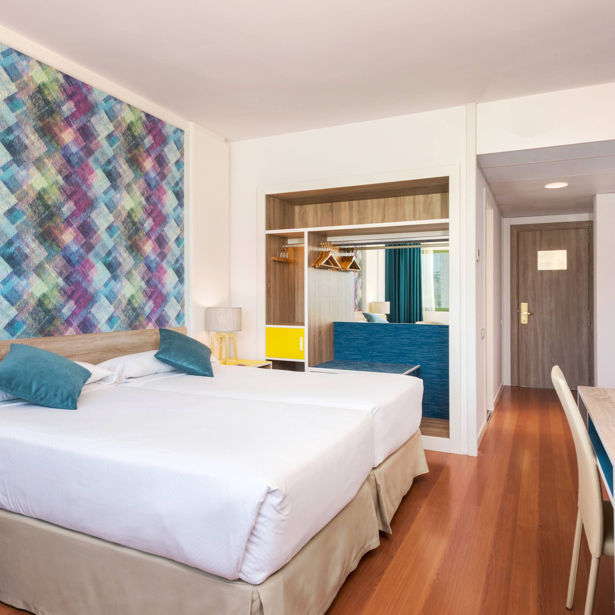 a room with two beds and a table