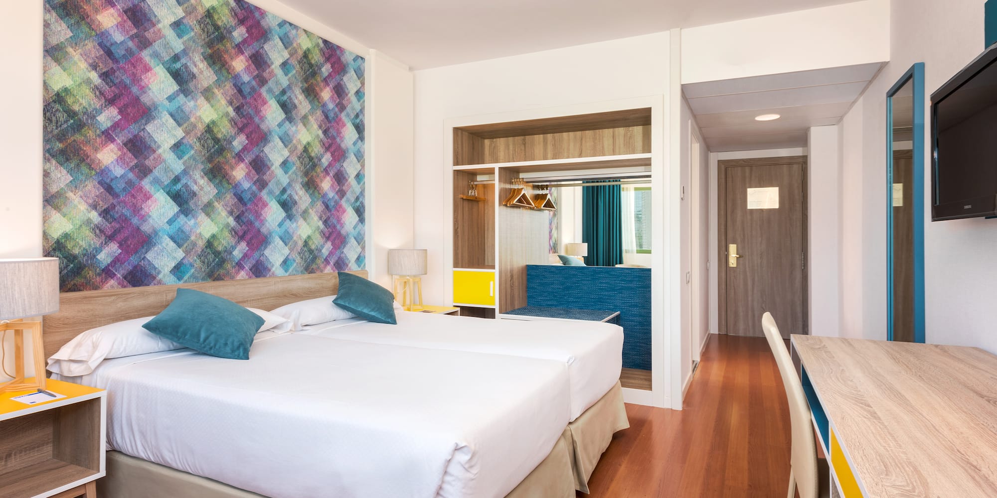 a room with two beds and a table