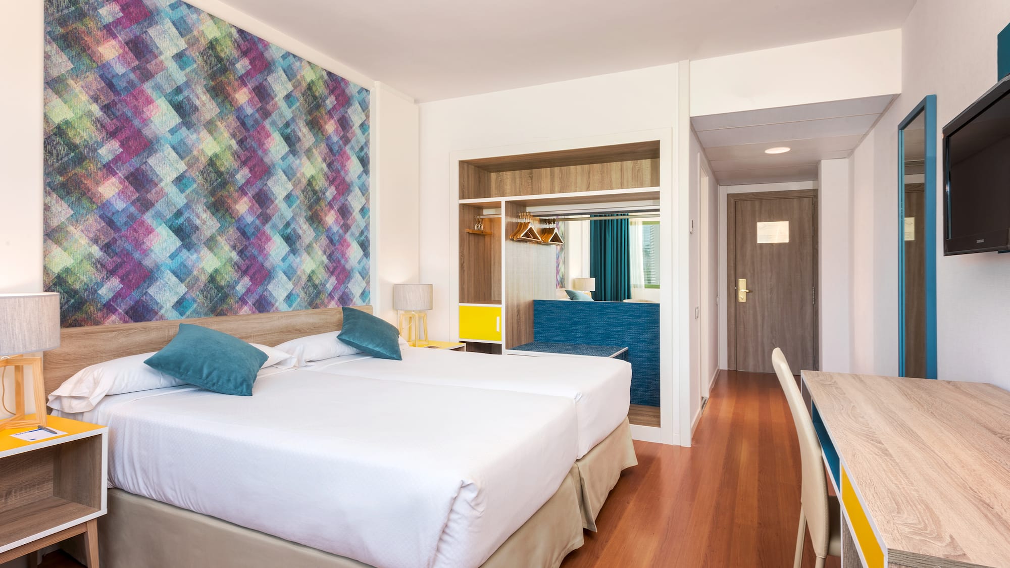 a room with two beds and a table