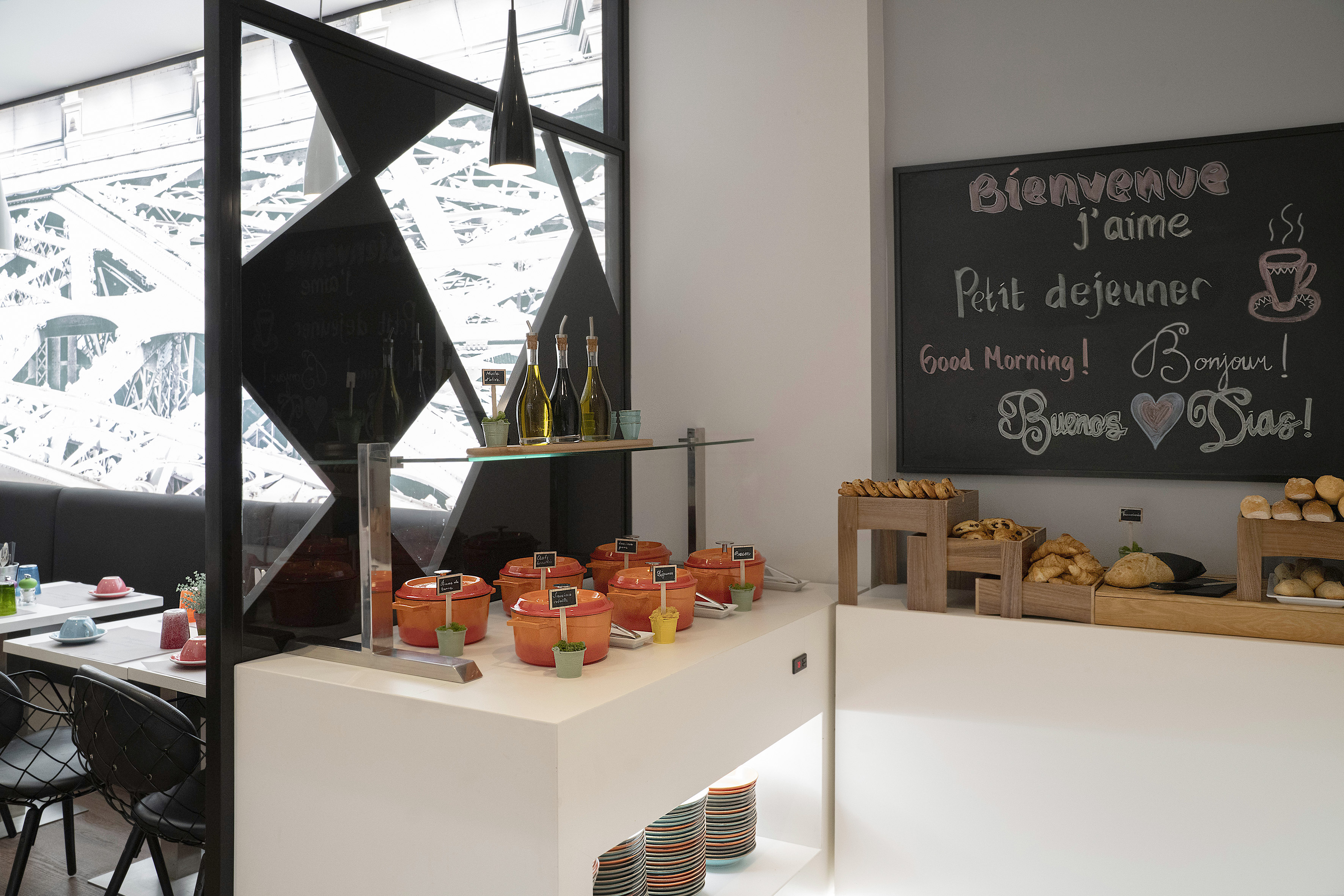 Breakfast buffet with hot food, pastries, and Eiffel Tower view in Paris.