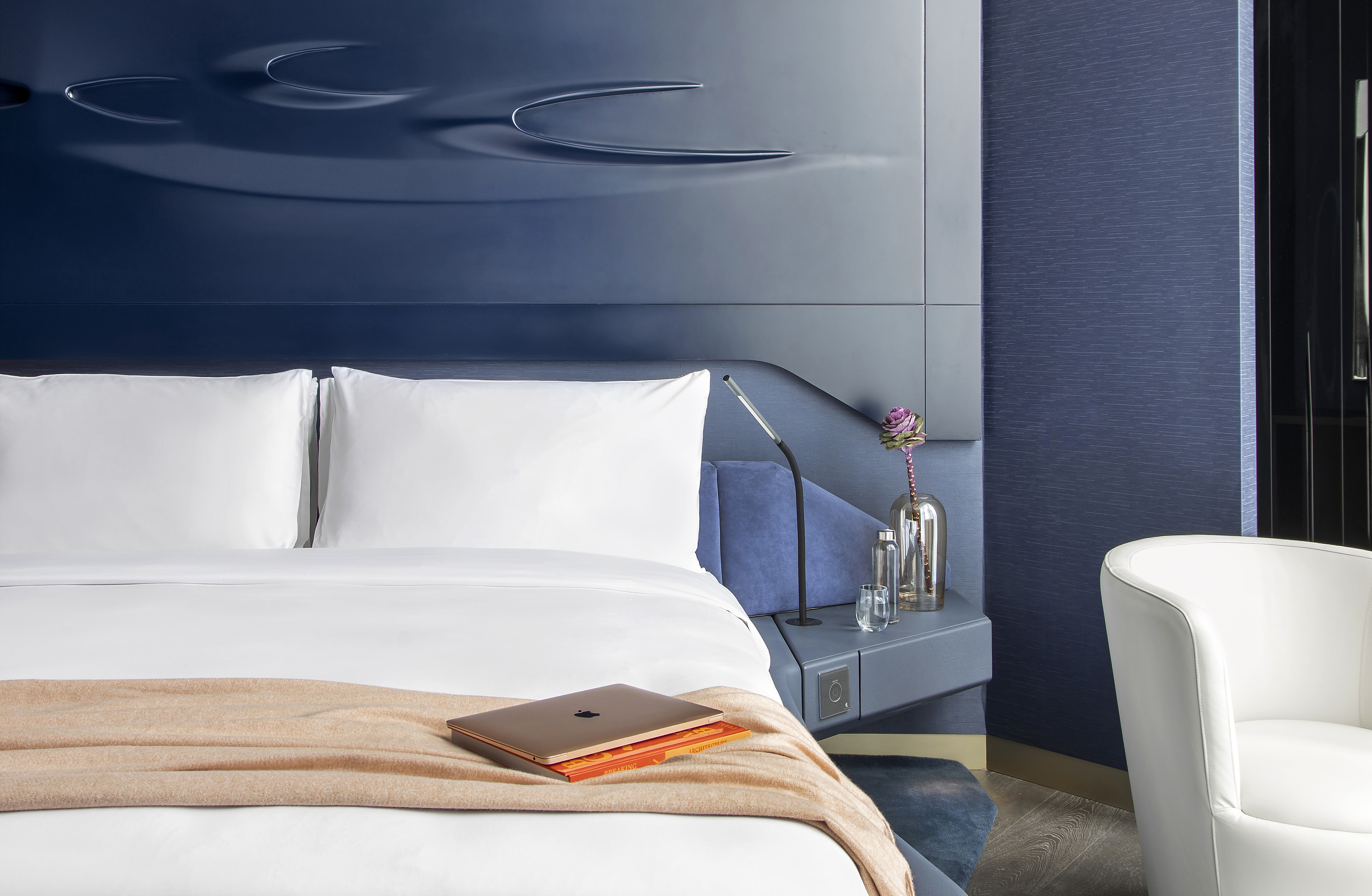 a bed with a laptop on it