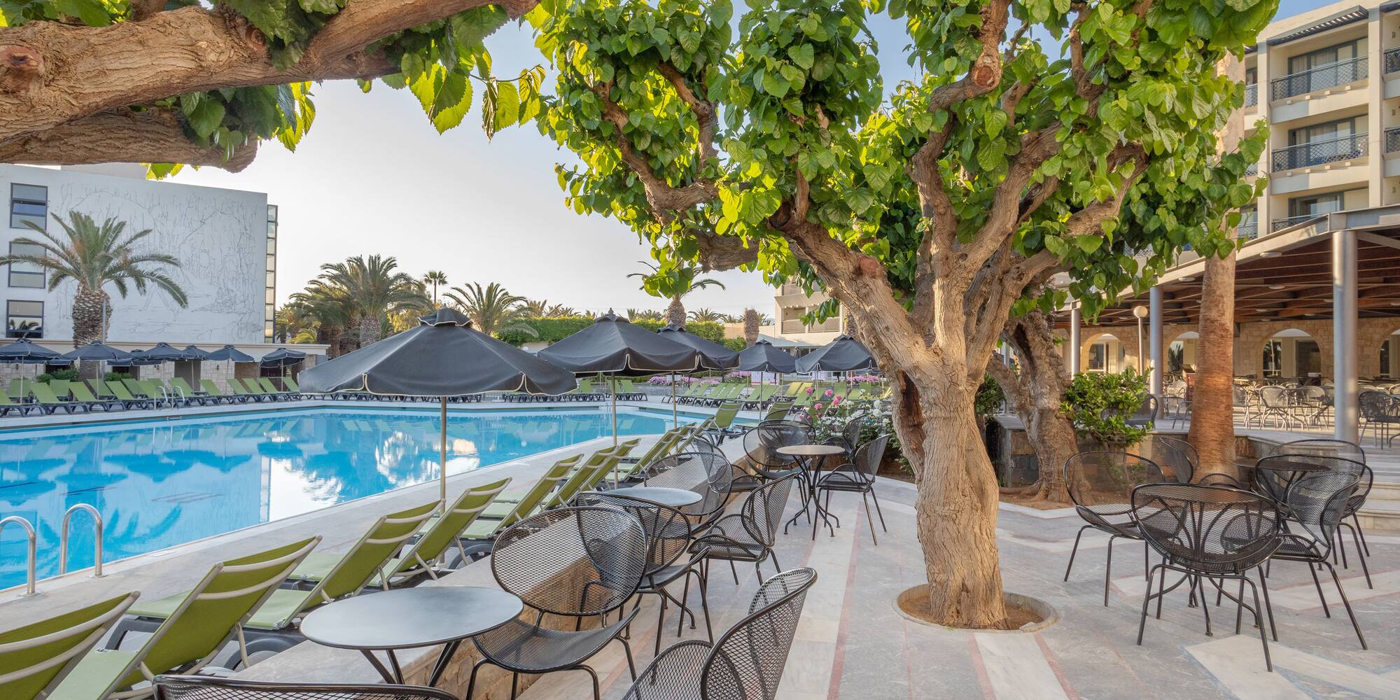 a pool with tables and chairs