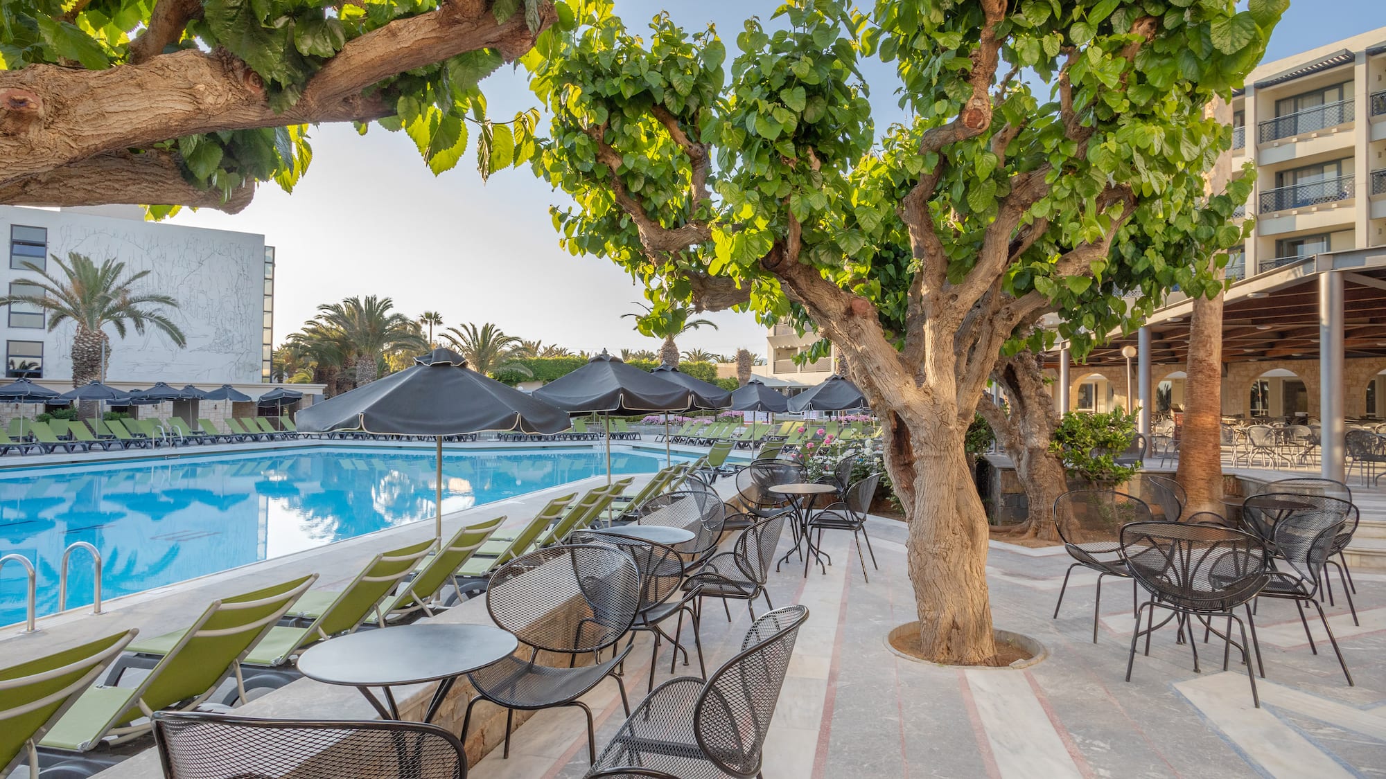 a pool with tables and chairs