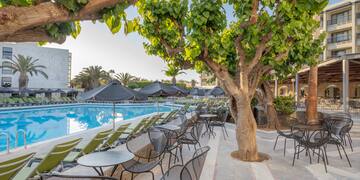 a pool with tables and chairs