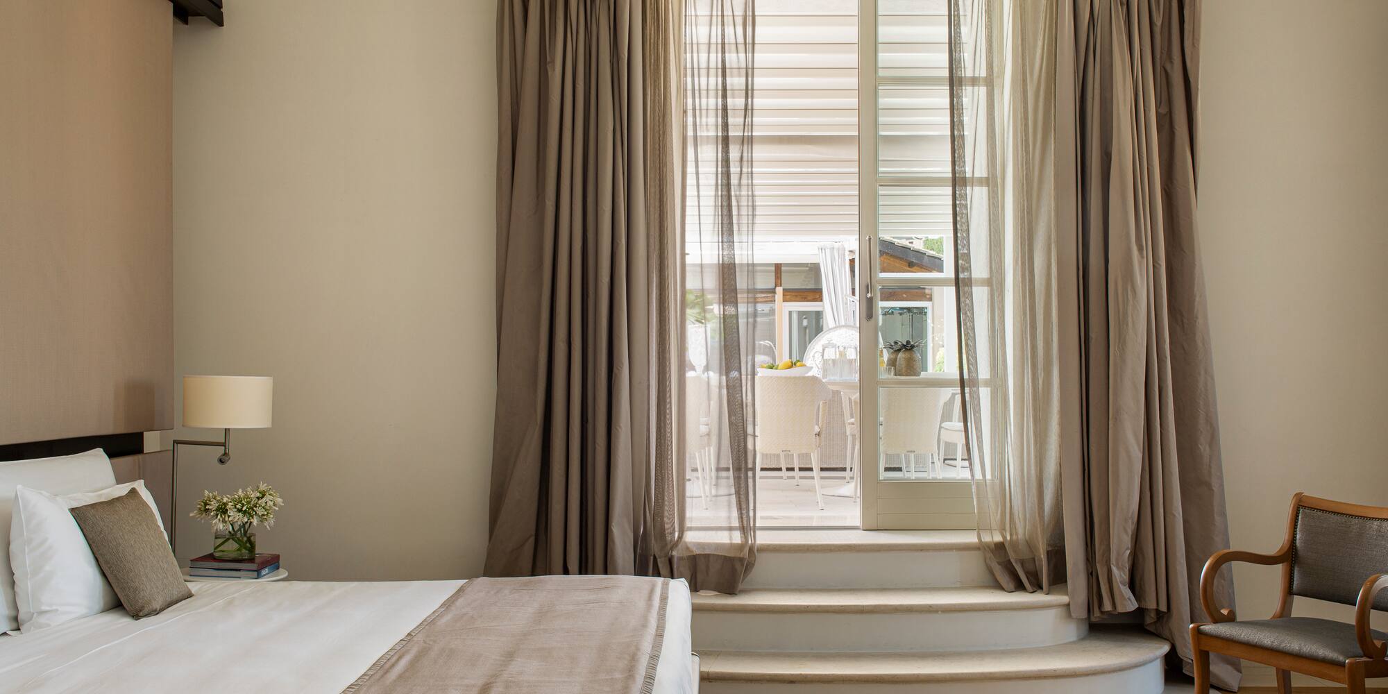 a bedroom with a bed and a chair