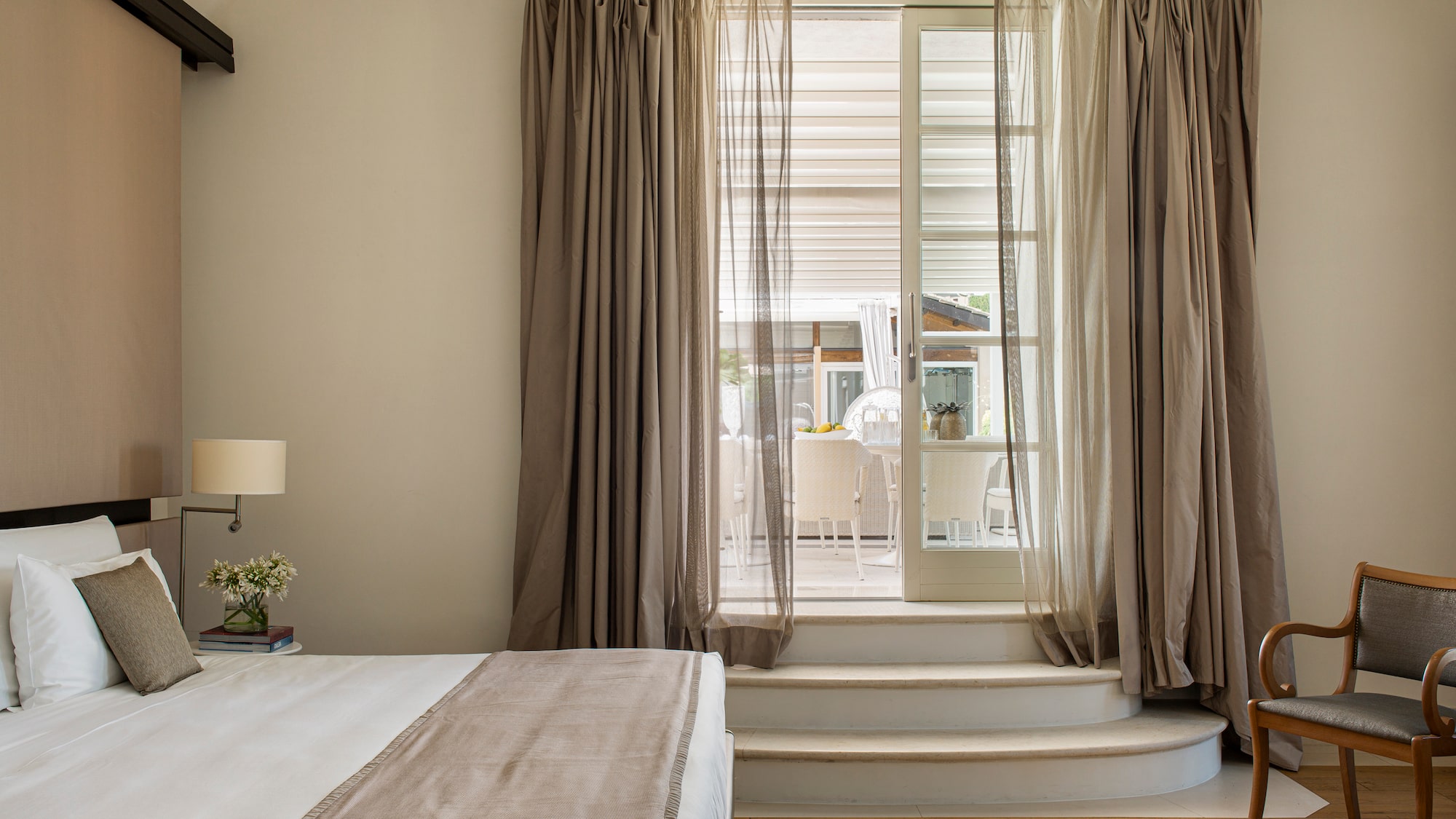 a bedroom with a bed and a chair