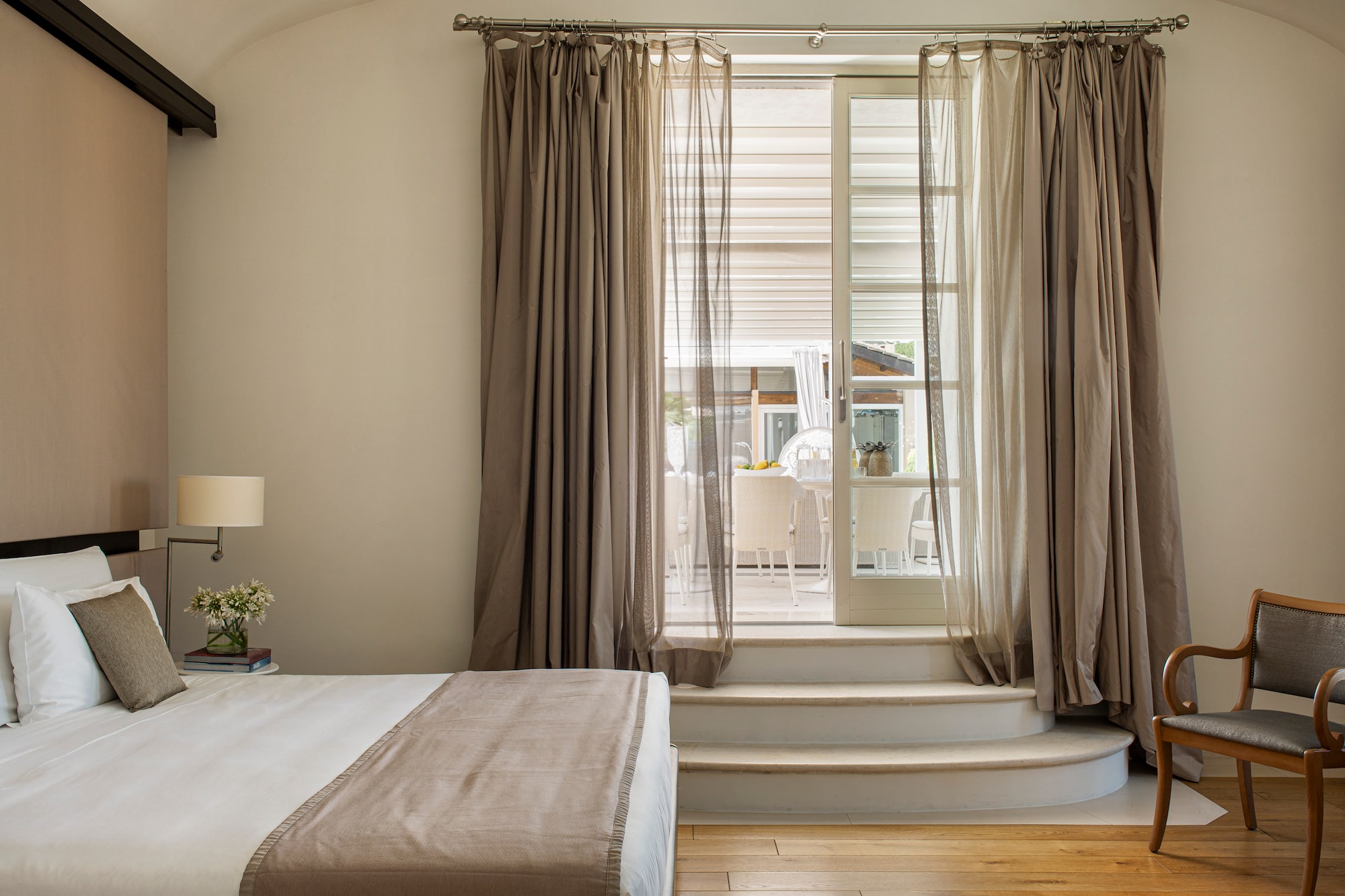 a bedroom with a bed and a chair