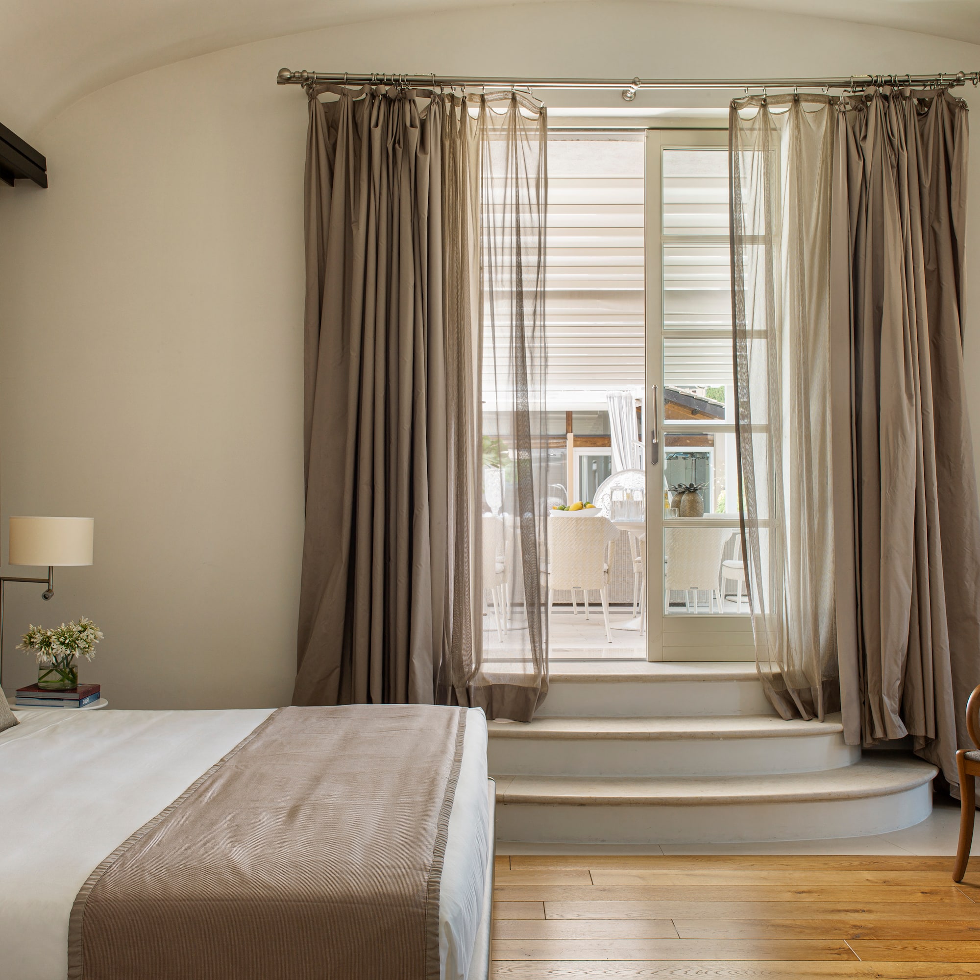 a bedroom with a bed and a chair